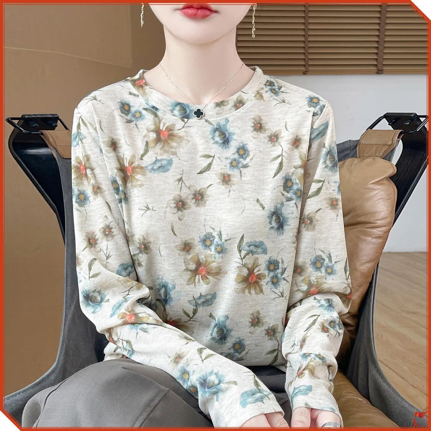 Women's round neck knitted pullover in a Tencel cotton blend with a printed floral design on the front.