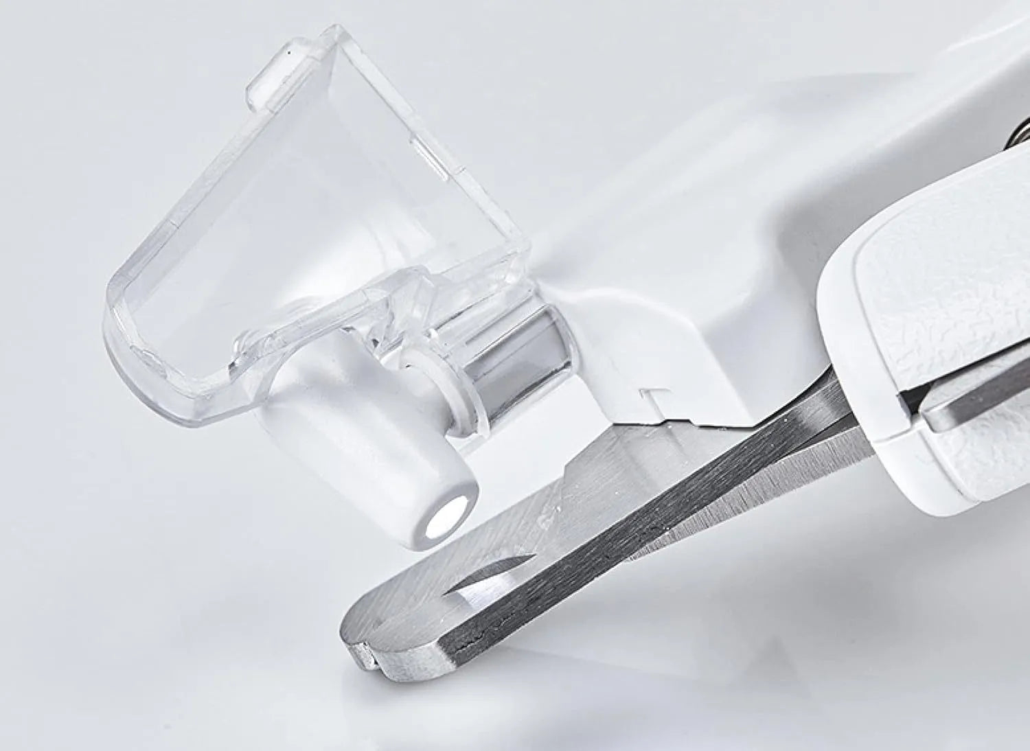 White pet nail clippers with LED light on blade and transparent anti-splash guard, shown with a nail file.