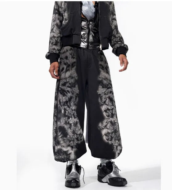 Man wearing a loose-fit printed trousers and hoodie set in a street style
