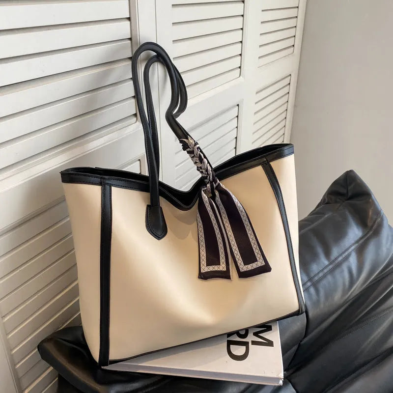 Soft PU leather square tote shoulder bag in black showing open outer pocket and internal phone compartment.