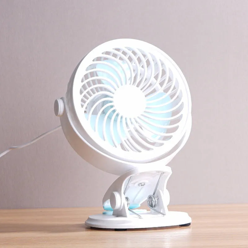 Compact USB desk fan shown in both clip-on and mini floor standing styles on a wooden desk.