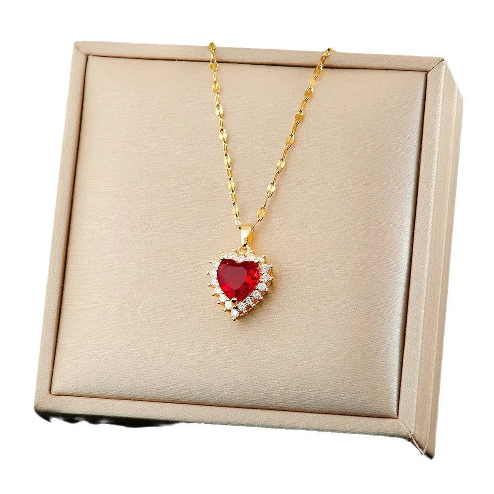 Gold-red titanium steel jewellery set for women with heart-shaped flower pendant, matching stud earrings, and ring.