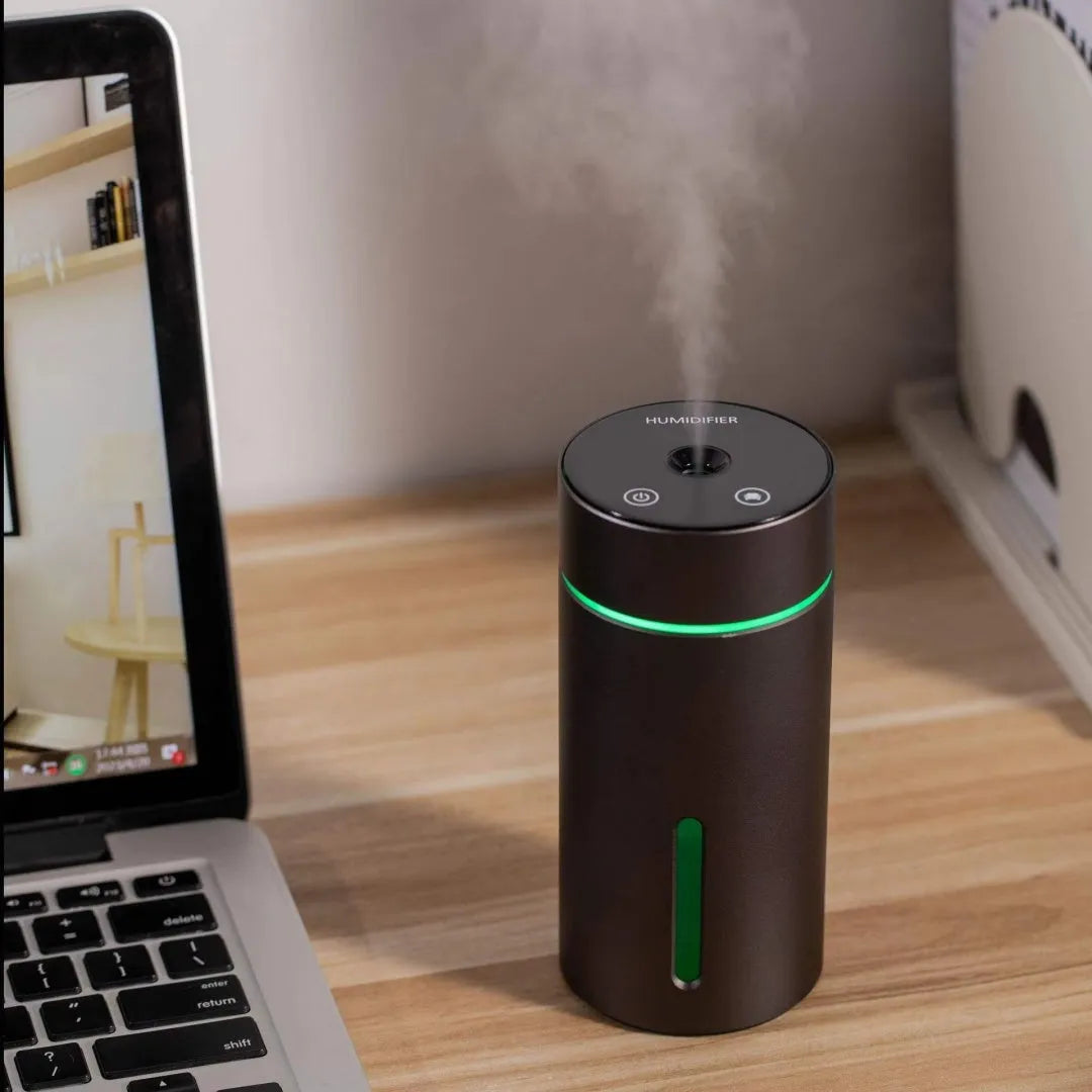Black aluminium portable car humidifier diffuser with night light on a car dashboard