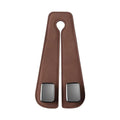 Black suede car seat hook attached to a headrest post, holding a shopping bag.