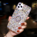Sparkling diamond acrylic phone case for Samsung Galaxy phone on a table.