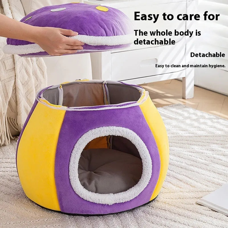 Grey mushroom-shaped plush cat bed with an entrance hole, shown on a wooden floor.