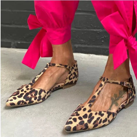 Leopard print women's court shoes with a pointed toe, cross strap, and a low chunky heel.