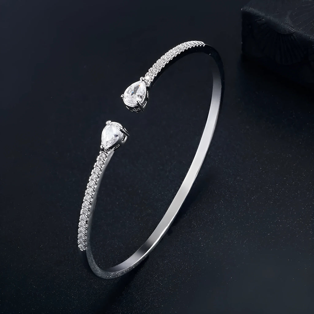 Multi-zircon copper bracelet with zircon inlaid detailing available in white or blue colour