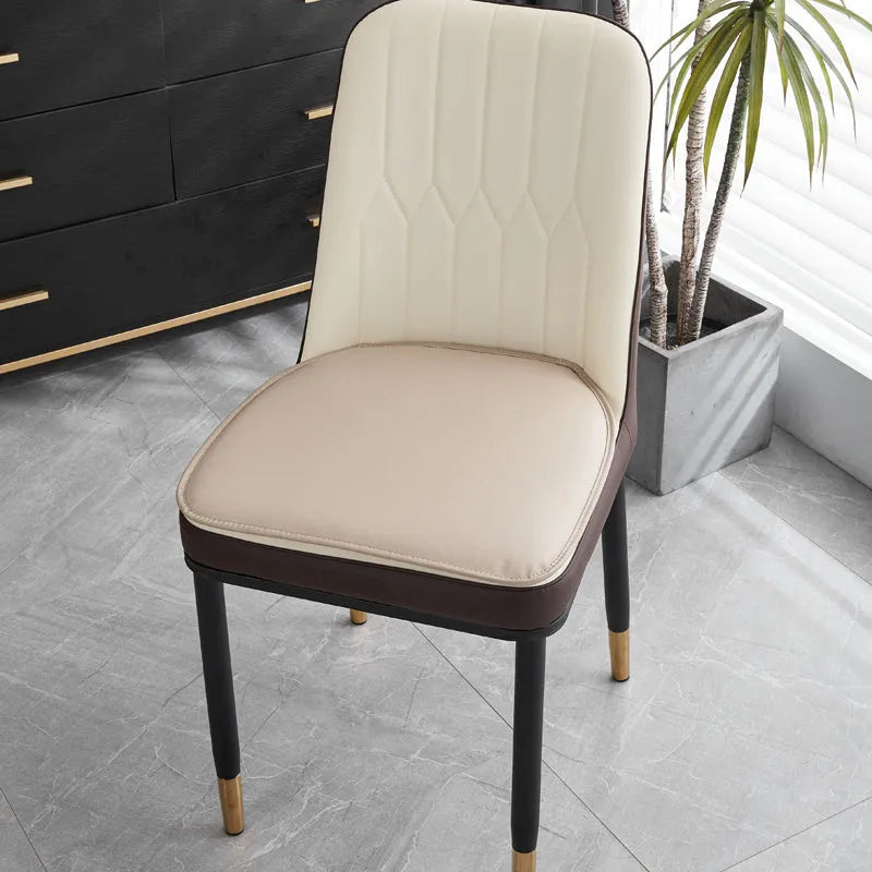 Leather horseshoe-shaped seat cushion in beige colour on a dining chair.