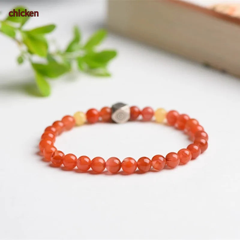 Natural Nanhong agate zodiac bracelet with a beeswax bead shown in 6mm and 8mm size options.