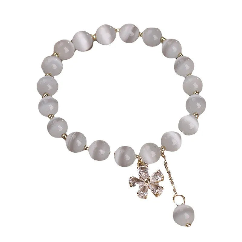 White cat's eye stone bracelet with flower tassel detail and morganite safety buckle pendant