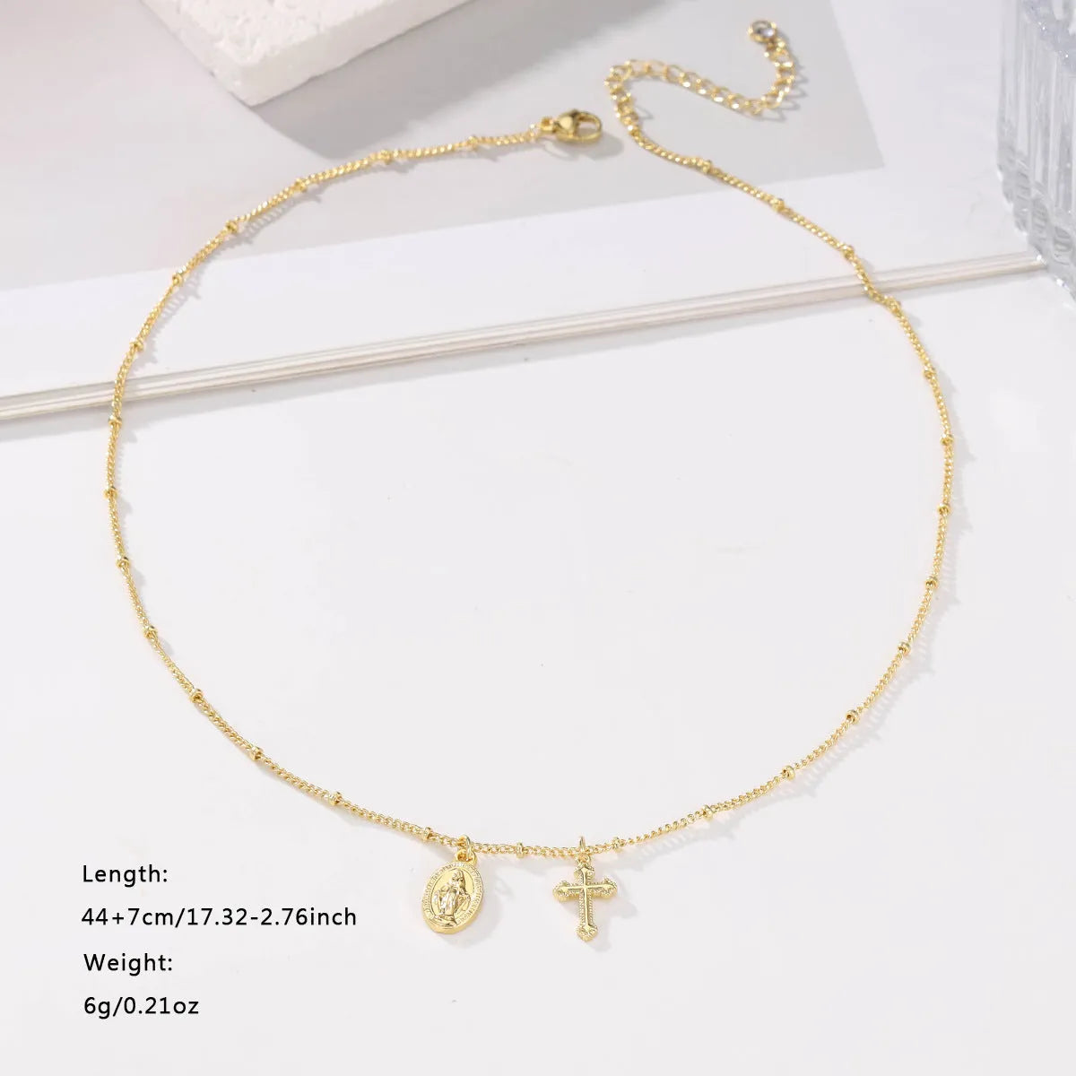 Virgin Mary cross necklace with geometric pendant in gold colour