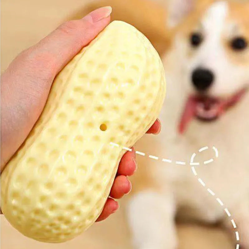 Yellow peanut-shaped dog chew toy with TPR rubber construction measuring 12x5.6cm