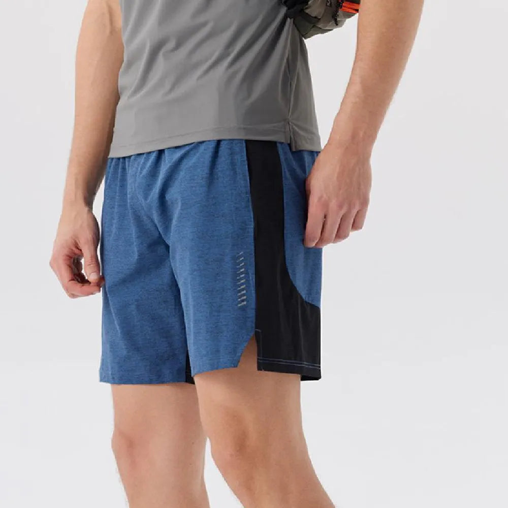 Man wearing forest green spandex five-point casual shorts, showing mid-waist fit and shorts length.