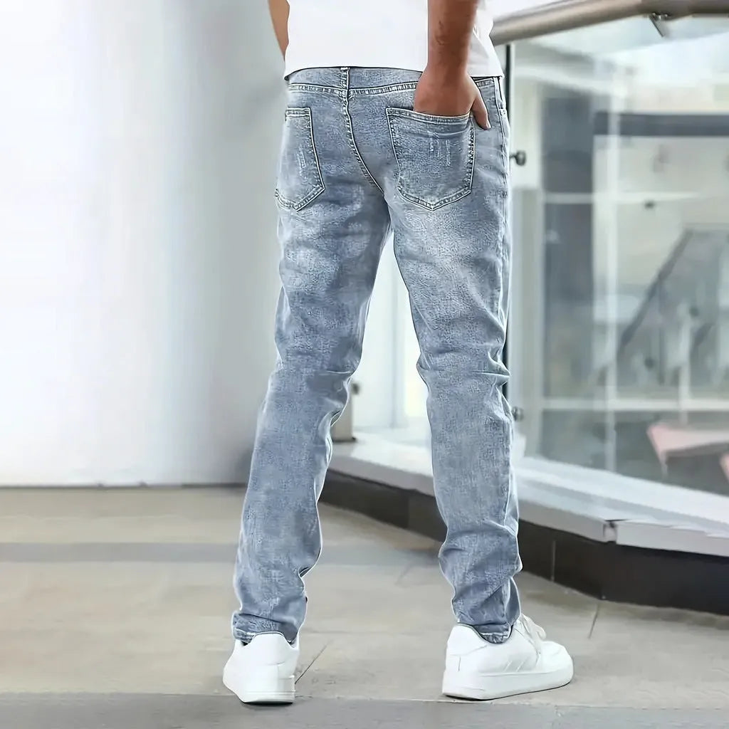 Men's black straight leg skinny stretch jeans with a mid waist and zipper fly.