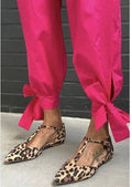 Leopard print women's court shoes with a pointed toe, cross strap, and a low chunky heel.