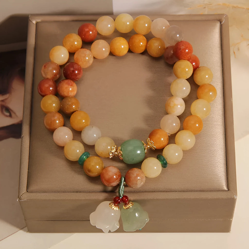 Natural jade multi-layer bracelet for women with an orchid pendant on an adjustable fastening.