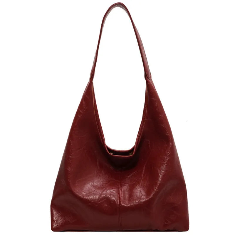 Casual soft PU leather shoulder bag in black with visible stitching and a front sandwich pocket.