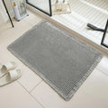 Checkered patterned absorbent bathroom carpet on floor showing non-slip woven base in beige colour.
