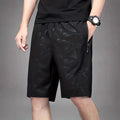 Men's loose black sports shorts with printed design for casual athletic wear and beach activities