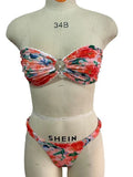 Women's floral print bikini set with lace trim on a backless tube top and matching briefs.