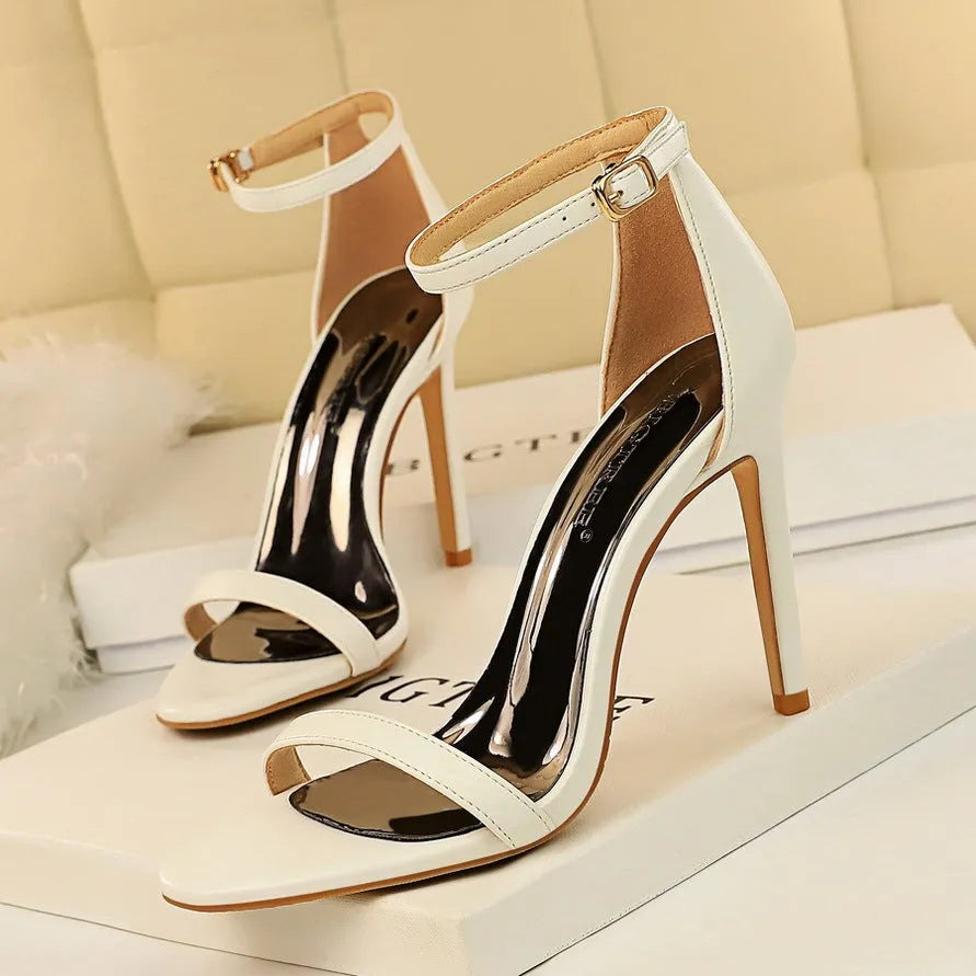 Women's open toe high heels with an ankle strap buckle, in a choice of six colours including red and silver.