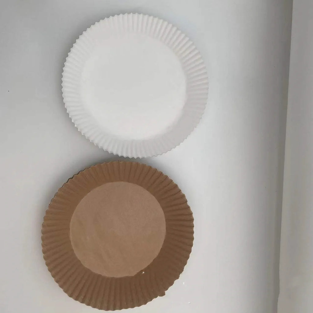 Round white disposable parchment paper liner for air fryer basket with raised edges.