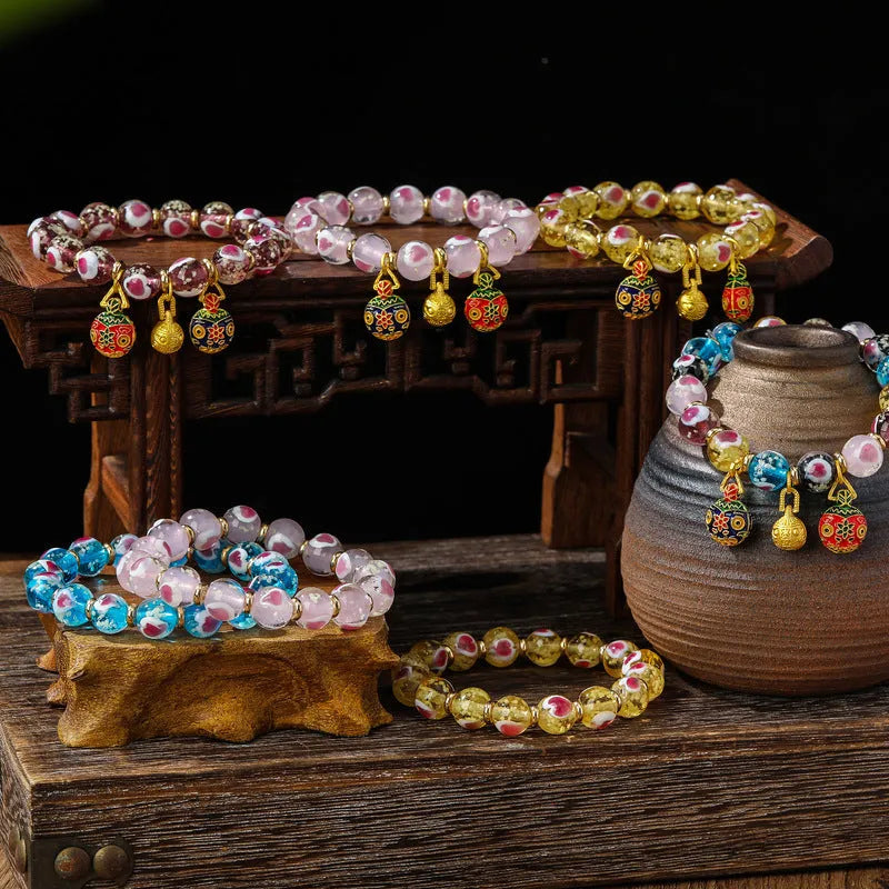 Handmade glass bracelet with swallow gold beast motifs and 10mm heart-shaped beads in multiple colour options