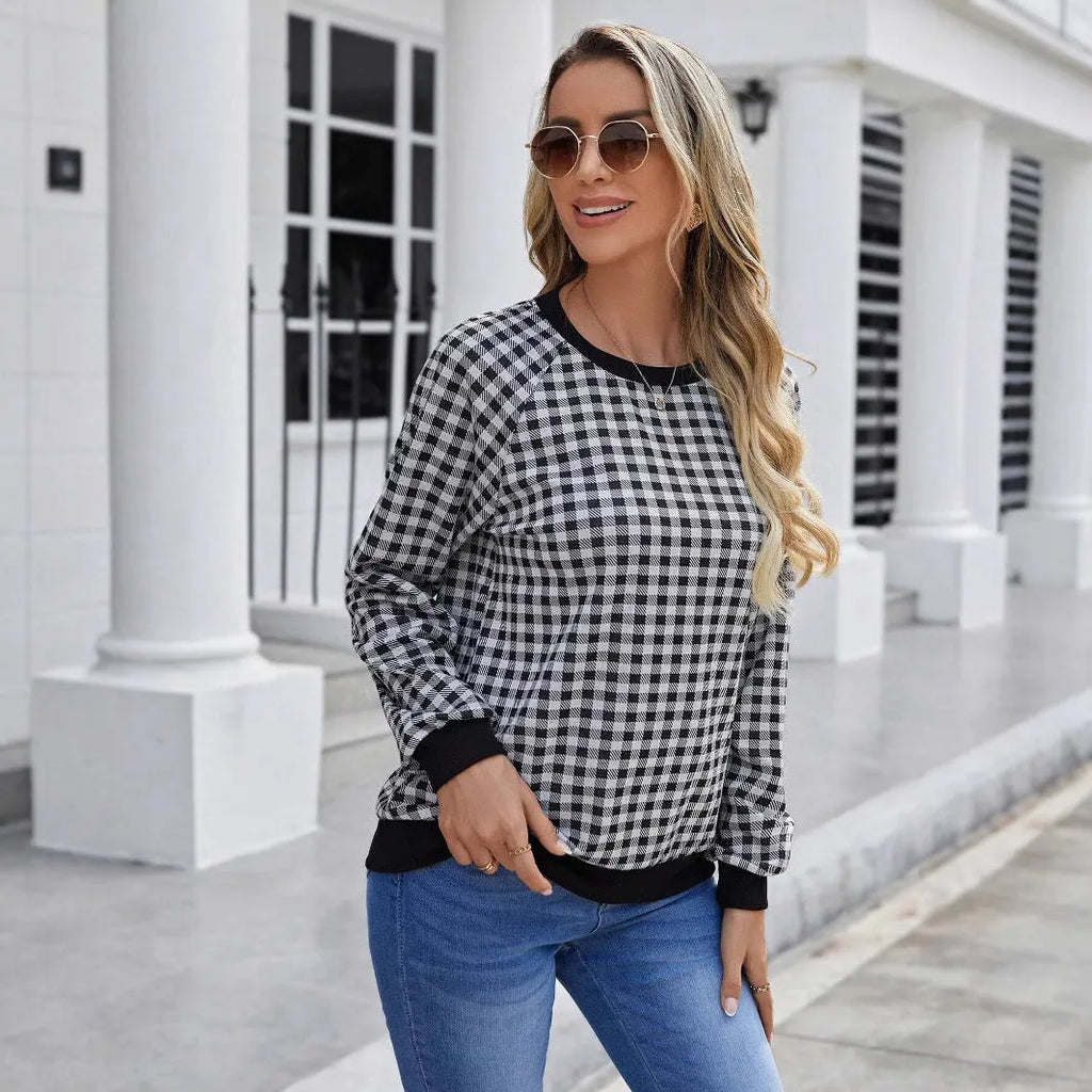 Black long sleeve pullover sweater with a striped plaid pattern, showing regular sleeve cut.