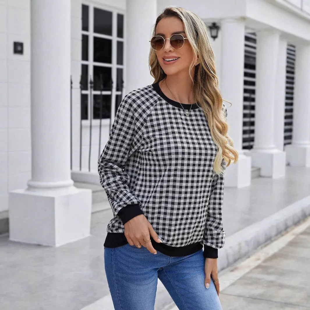 Black long sleeve pullover sweater with a striped plaid pattern, showing regular sleeve cut.
