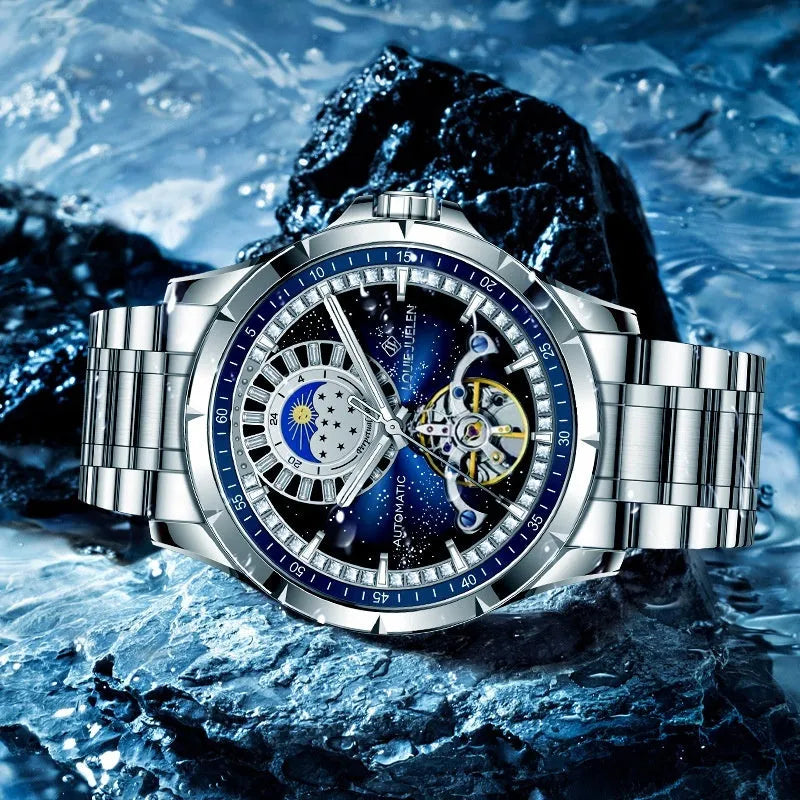 Men's silver alloy automatic watch with blue dial and stainless steel bracelet on wrist.