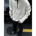 A solid colour loose pullover top with long sleeves, shown in apricot, grey and black.
