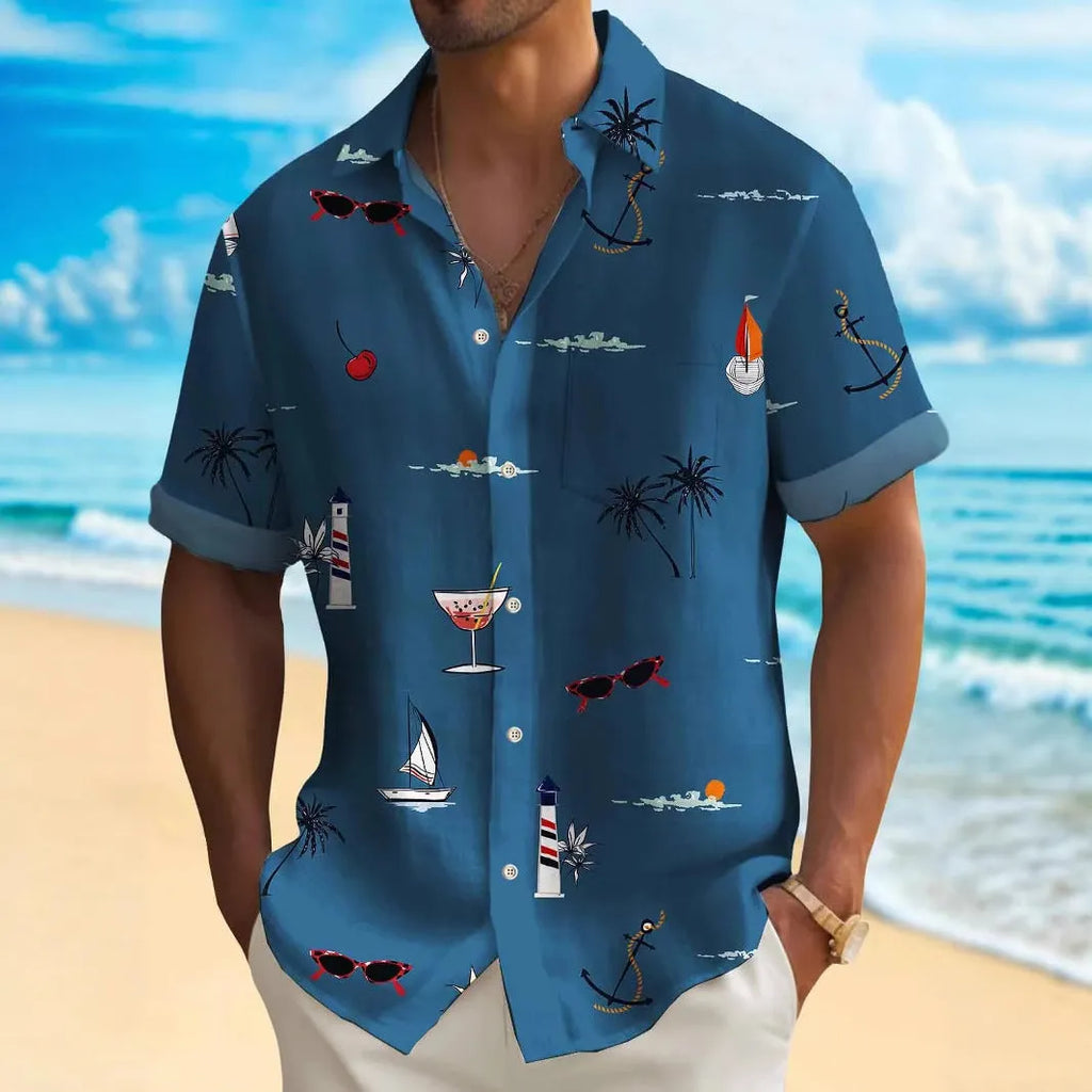 Man wearing a colourful loose-fit Hawaiian print short sleeve shirt on a beach.