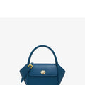 Women's wing-shaped leather tote bag with a latch buckle, shown in Atlantic blue with a cross-body strap.