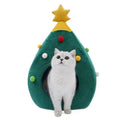 Red Christmas tree shaped plush cave bed for cats and small dogs on a wooden floor.