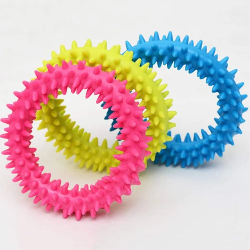 Blue TPR spiked ring dog chew toy for dental cleaning and bite training on a white background.