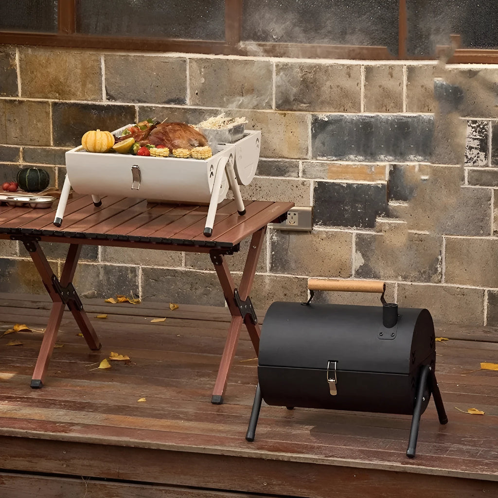 White round portable charcoal grill with chimney oven net, folding for storage.