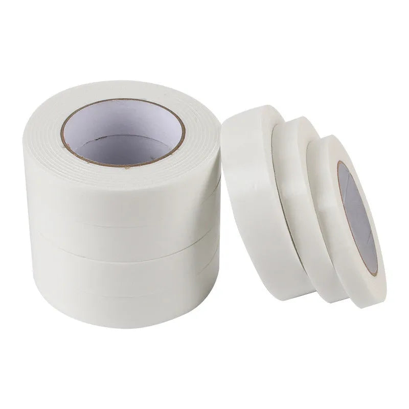 Roll of 3mm thick white foam double-sided adhesive tape showing its spongy core and strong adhesive on both sides.