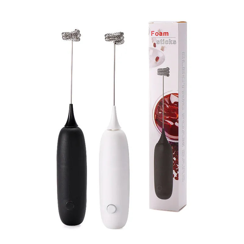 Black and white hand-held electric milk frother blender on kitchen counter