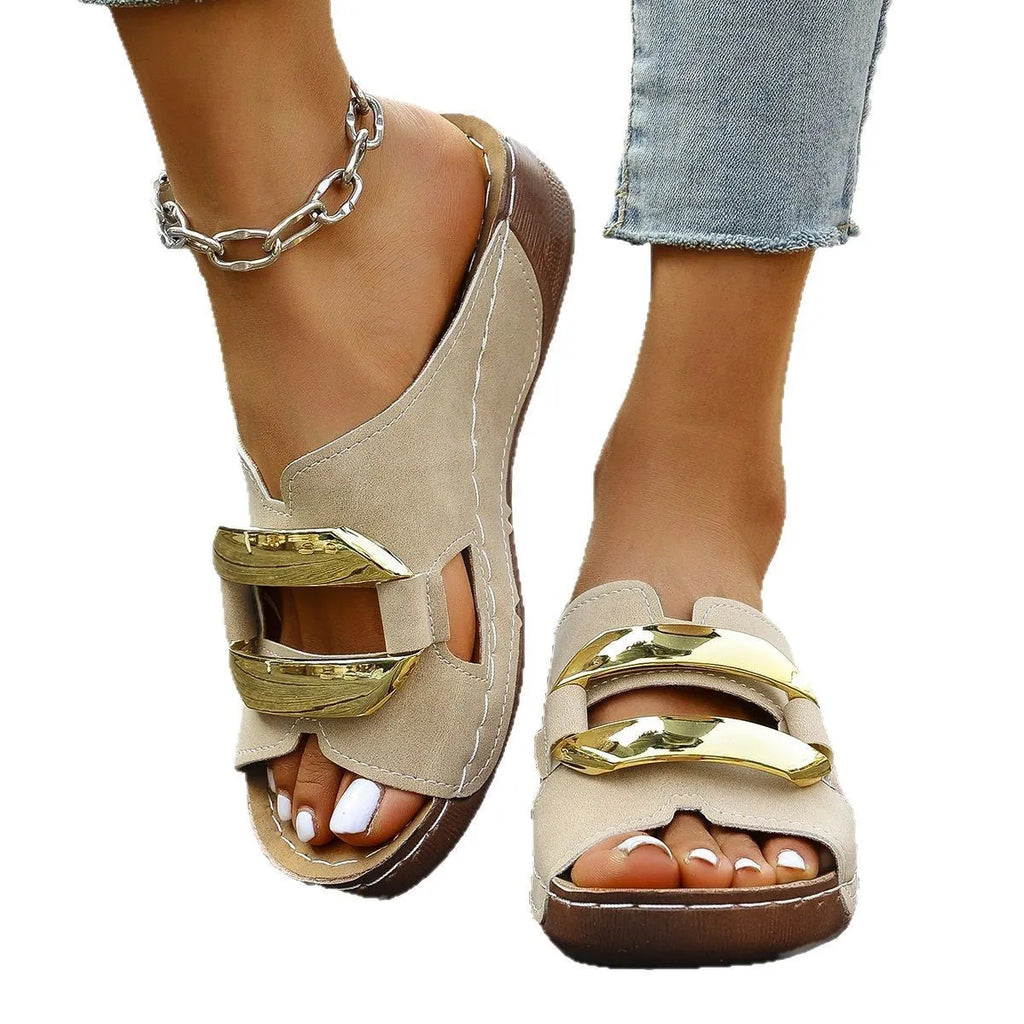 Roman style platform sandals in black with metal details and a rubber sole.