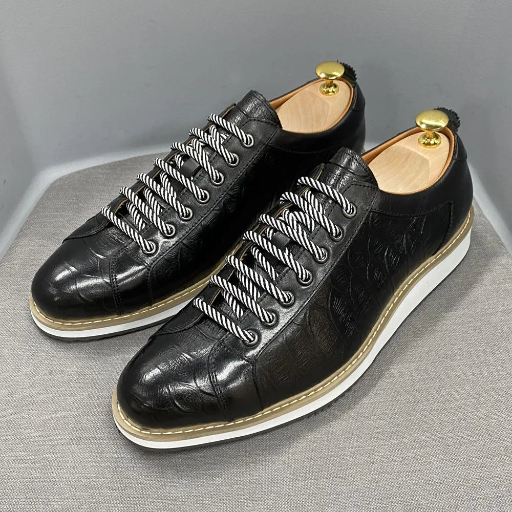 Men's low-top black embossed pattern handmade lace-up shoes on a white background.