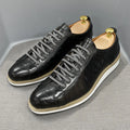 Men's low-top black embossed pattern handmade lace-up shoes on a white background.