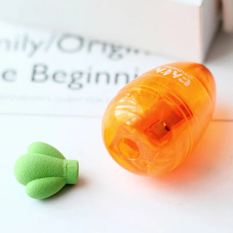 Carrot-shaped plastic manual pencil sharpener with extended handle on a white background.