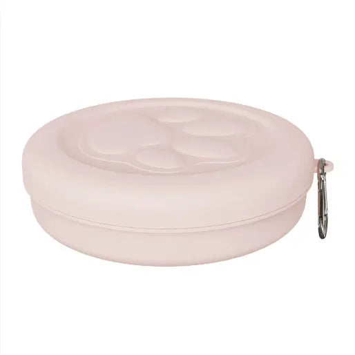Two-tone portable dog bowl with attached snack box for outdoor feeding.