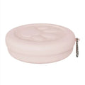 Two-tone portable dog bowl with attached snack box for outdoor feeding.
