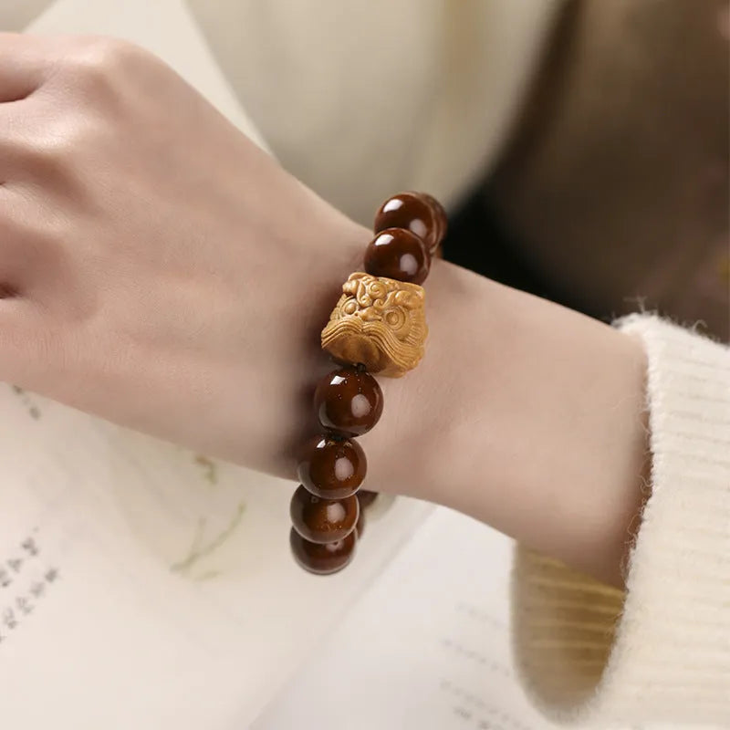 Hand-woven 13mm round bead bracelet in ivory nut lion style with single circle design