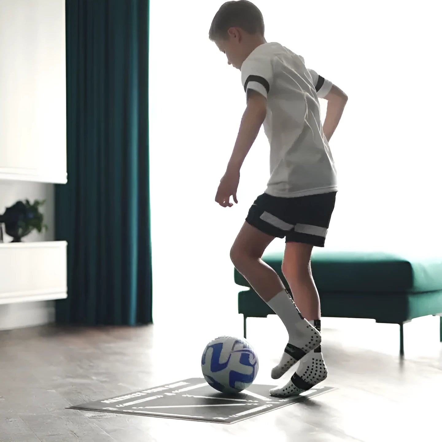 Black football training mat with grid markings measuring 60x90cm for non-slip skills practice
