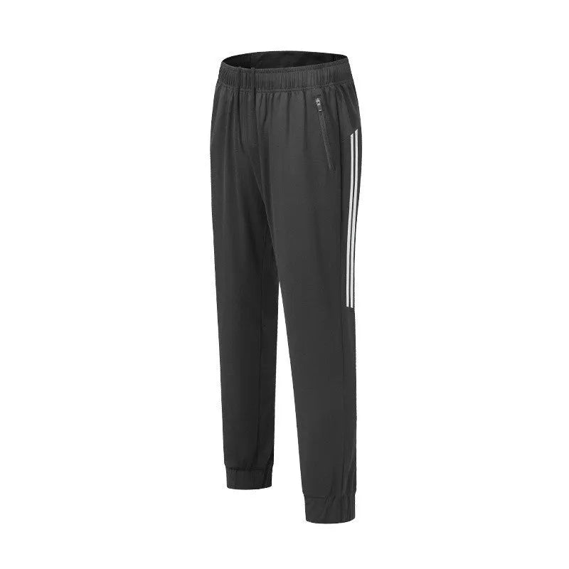 Man wearing black mid-waist polyester running pants for exercise.
