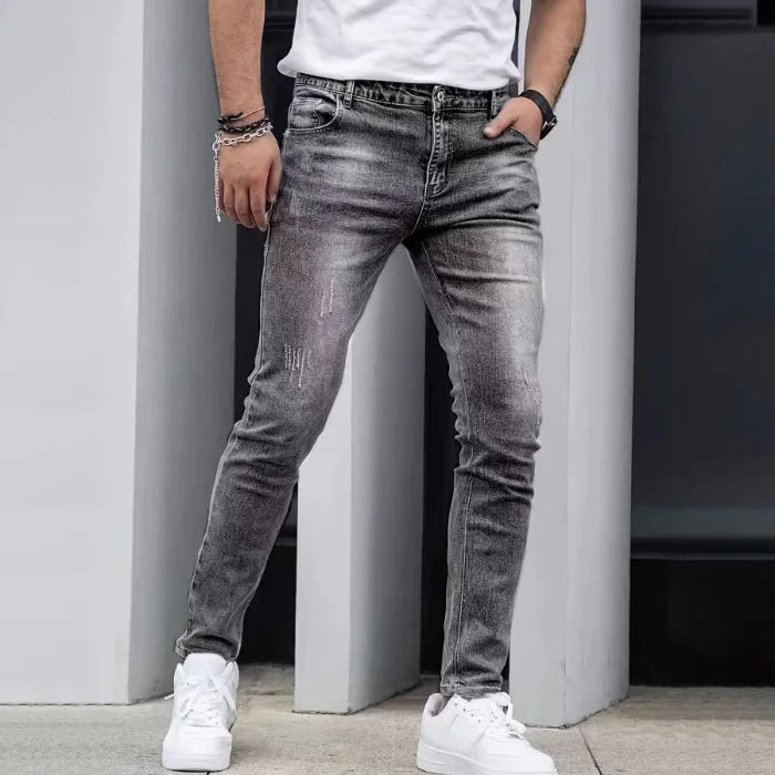Men's black straight leg skinny stretch jeans with a mid waist and zipper fly.