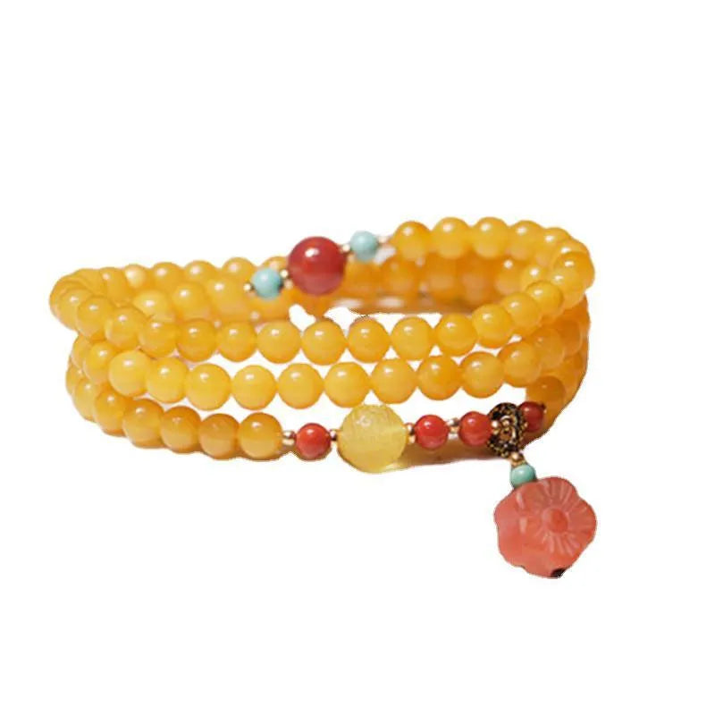 Yellow amber bracelet with 5mm round shape and animal zodiac design in retro style.